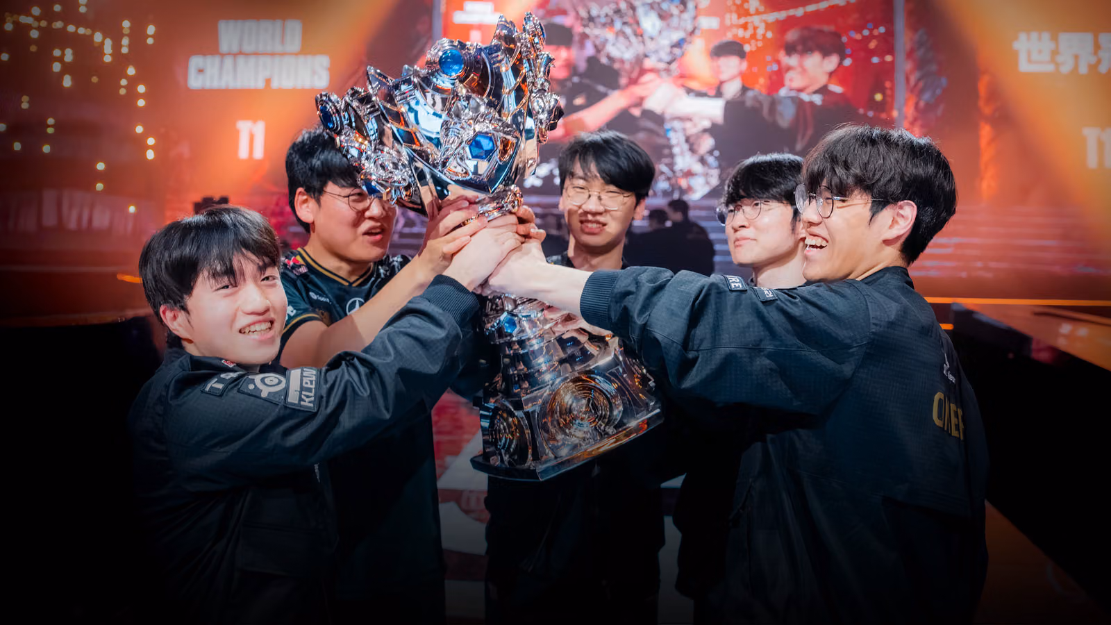 T1 players celebrating with the Summoner's Cup after winning the 2025 League of Legends World Championship