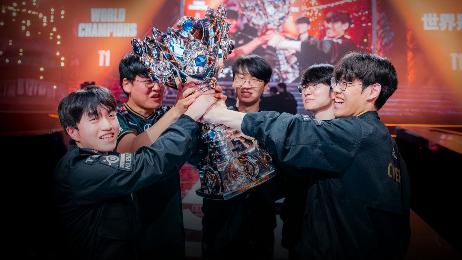 T1 players celebrating with the Summoner's Cup after winning the 2025 League of Legends World Championship